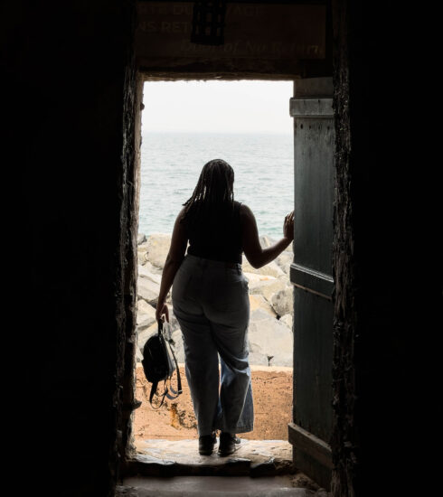 An African-American woman stands in the 'Door of No Return' on Gorée Island, Senegal.
