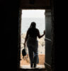 An African-American woman stands in the 'Door of No Return' on Gorée Island, Senegal.